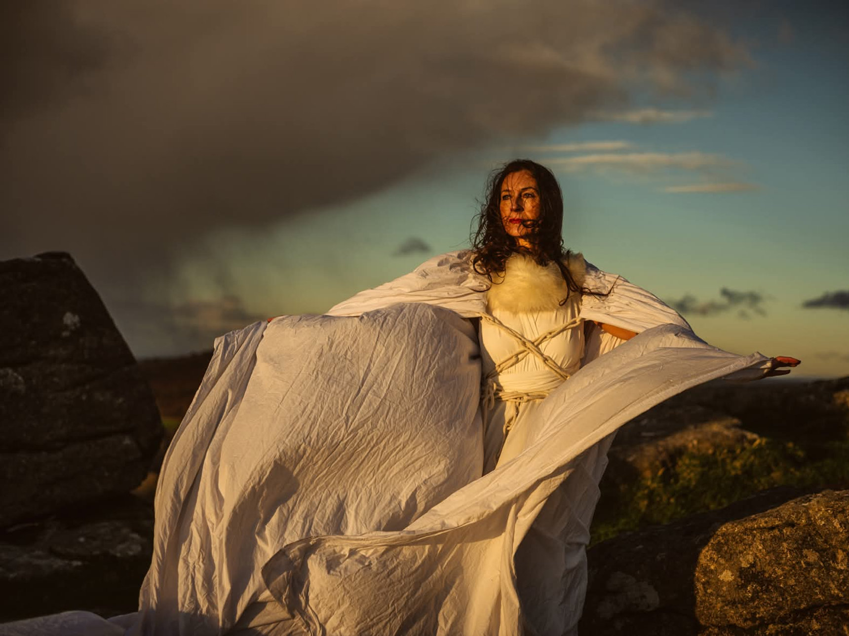 Tara Beckerley on the moor in a flowing white cloak
